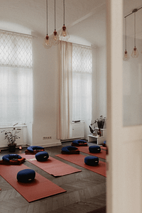 The main room of Holographic Healing Nest with yoga mats and cushions